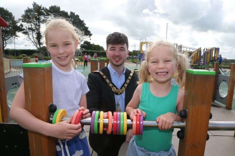 The Mayor of Causeway Coast and Glens Borough Council Councillor Sean Bateson pictured with Emilia and Bethany at the Diversity Park in Portstewart.