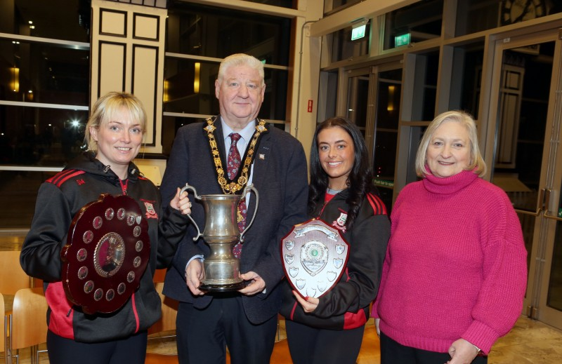 Shauneen Mullan, captain of Drumsurn GAC Camogie team and vice-captain Caitlin Cassidy with Councillor Brenda Chivers and Mayor of Causeway Coast and Glens, Councillor Steven Callaghan.