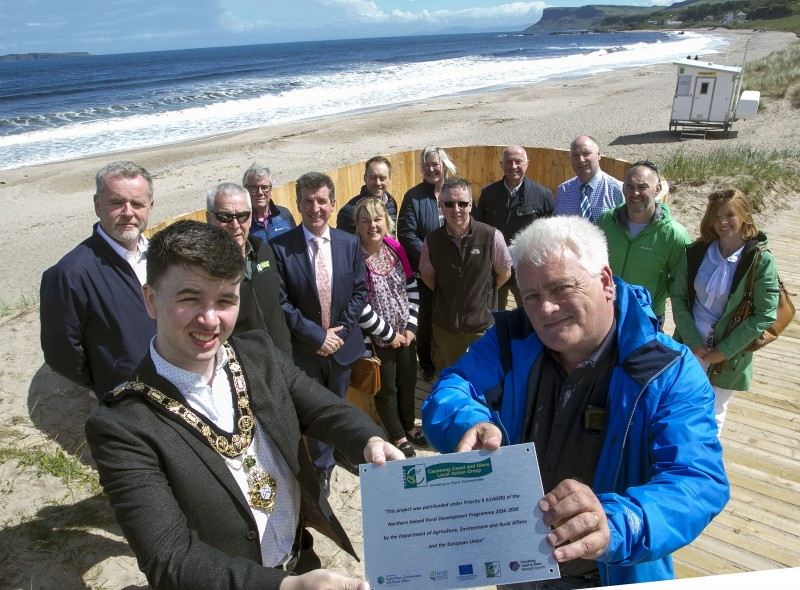 The Mayor of Causeway Coast and Glens Borough Council Councillor Sean Bateson pictured at the completion of the Coastal and Dune Management project at Ballycastle beach with Gareth Evans, Rural Development Programme Manager, DAERA, (back row) Charlie Brooks, Beaches and Resorts Officer, Causeway Coast and Glens Borough Council, Mark Strong, Coast and Countryside Officer, Causeway Coast and Glens Borough Council, Councillor Sandra Hunter, Steven Mc Cartney, Holiday and Leisure Parks Manager, Causeway Coast and Glens Borough Council, Peter Thompson, Head of Tourism and Recreation, Causeway Coast and Glens Borough Council, (middle row) Kevin Mc Clelland, Capital Project Officer, Causeway Coast and Glens Borough Council, Nigel Mc Fadden, Rural Development Project Claims & Monitoring Officer, Causeway Coast and Glens Borough Council, Colm Mc Nicholl, JPM Contracts, Councillor Margaret Anne Mc Killop, Michael Mc Conaghy, Coast and Countryside Officer, Causeway Coast and Glens Borough Council, Richard Gillen, Coast and Countryside Manager and Kerrie Mc Gonigle, Destination Manager, Causeway Coast and Glens Borough Council.