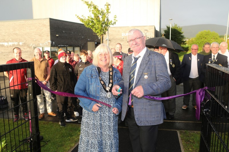 Denis McMacken and Deputy Mayor Margaret-Anne McKillop cut the ribbon at the official opening of Dungiven Bowling Club’s new synthetic bowling green.