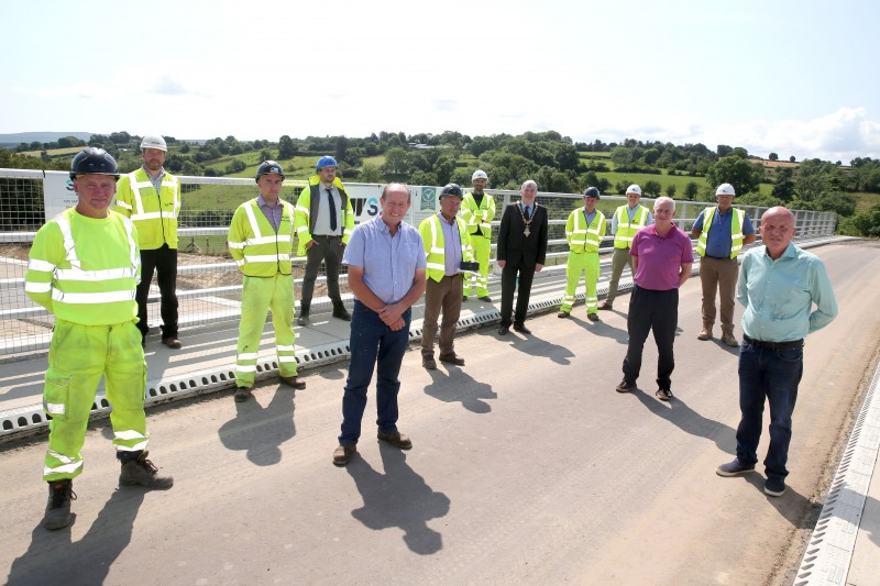 The Mayor of Causeway Coast and Glens Borough Council Councillor Richard Holmes pictured with Councillor Sean McGlinchey, Councillor Dermot Nicholl, Ian Buchanan and some of those involved with the construction of the A6 road scheme in Dungiven.