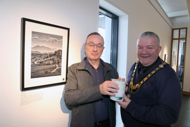 The Mayor of Causeway Coast and Glens Borough Council, Councillor Ivor Wallace, pictured with John Williams and his winning photograph.