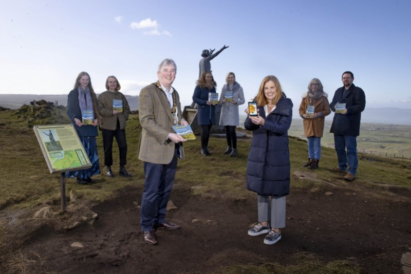 Pictured at Gortmore View Point for the launch of the new Echoes of the Causeway Coast heritage trail smartphone app are, front row, the Mayor of Causeway Coast and Glens Borough Council Councillor Richard Holmes, Causeway Coast and Glens Destination Manager Kerrie McGonigle, back row, writer Claire Savage, Dr Helen Jackson (Ulster University), Collette Quigley and Linda McCracken (Big Telly), writer Moyra Donaldson, and Causeway Coast and Glens Borough Council Museum Services Engagement Officer Nic Wright.