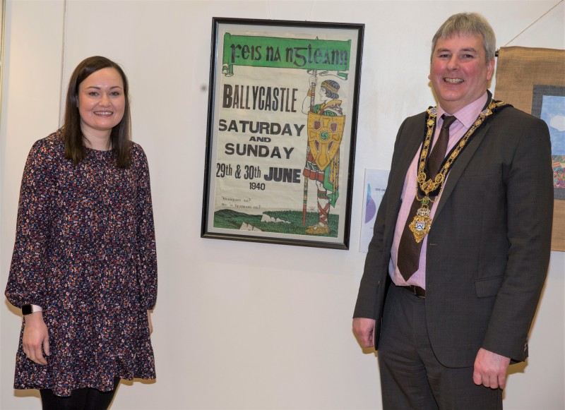 Museum Services Assistant Rachel Archibald and the Mayor of Causeway Coast and Glens Borough Council Councillor Richard Holmes with a poster from Feis na nGleann dating back to 1940 which is on display in the new ‘100 Objects for 100 Years’ exhibition in Ballymoney Museum.