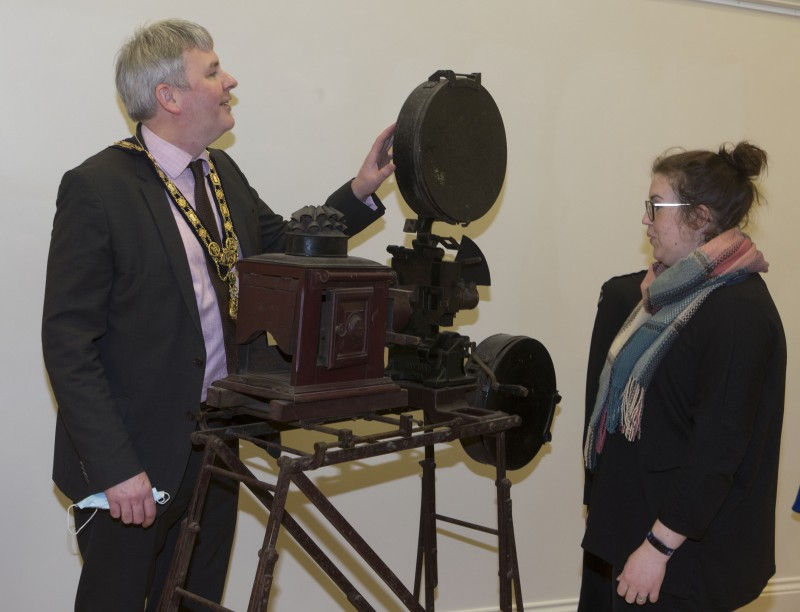 Museum Services Officer Sarah Carson shows the Mayor of Causeway Coast and Glens Borough Council Councillor Richard Holmes a projector used to show silent films in St Patrick’s Hall Ballymoney.