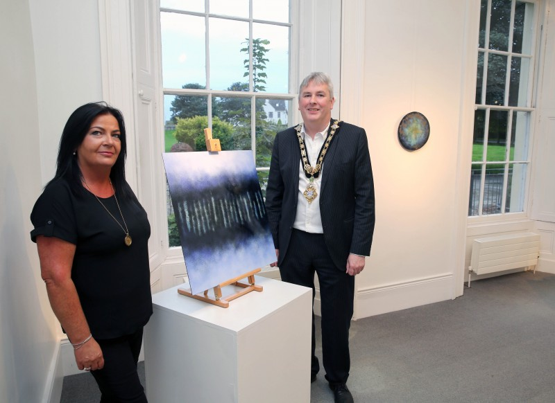 The Mayor of Causeway Coast and Glens Borough Council Councillor Richard Holmes pictured with Duty Manager Shona Kerr during his visit to Susan Mannion’s ‘Beyond Darkness’ exhibition at Flowerfield Arts Centre