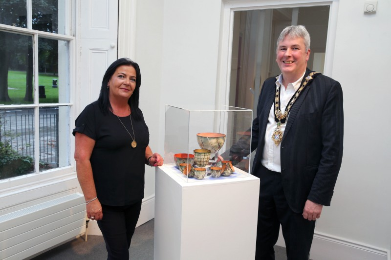 The Mayor of Causeway Coast and Glens Borough Council Councillor Richard Holmes pictured with Duty Manager Shona Kerr during his visit to Susan Mannion’s ‘Beyond Darkness’ exhibition at Flowerfield Arts Centre