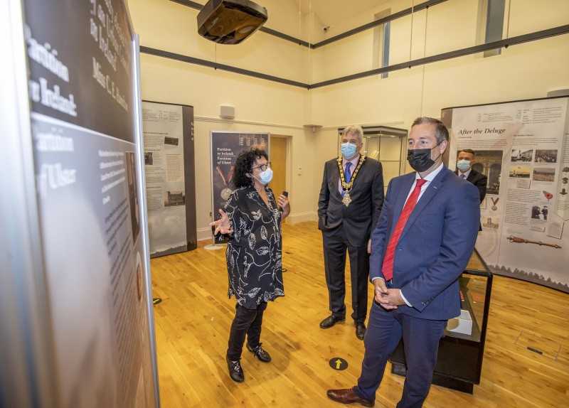 The Mayor of Causeway Coast and Glens Borough Council, Councillor Richard Holmes and First Minister Mr Paul Givan enjoy a tour of the ‘1919 - 1922 Partition in Ireland: Partition of Ulster’ exhibition at Ballymoney Museum with Helen Perry, Causeway Coast and Glens Borough Council Museum Services Development Manager.