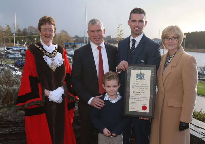 Richard Chambers pictured with his parents and young son alongside the Mayor following the Freedom Ceremony.