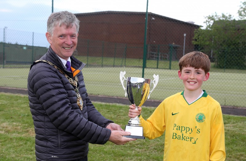 Matthew McCamphill, captain of Dunloy FC, section 1 winners of Pappy’s Bakery Friendship Soccer League accepts the cup from Mayor of Causeway Coast and Glens Borough Council Alderman Mark Fielding.