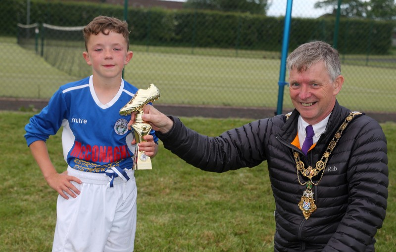 Boys Player of The League, Oscar Spence from Stranocum Youths, receives his trophy from the Mayor of Causeway Coast and Glens Borough Council Alderman Mark Fielding.