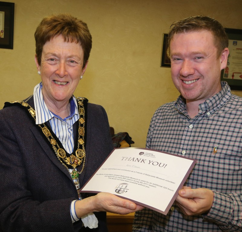 Caoimhin Mac Gabhann pictured receiving a certificate from The Mayor of Causeway Coast and Glens Borough Council, Councillor Joan Baird OBE, for his work as a museum volunteer.