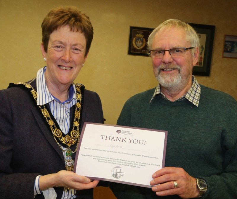 The Mayor of Causeway Coast and Glens Borough Council, Councillor Joan Baird OBE, pictured awarding Roger Peritt with a certificate to mark his contribution as a volunteer in the Friends of Ballycastle museum.