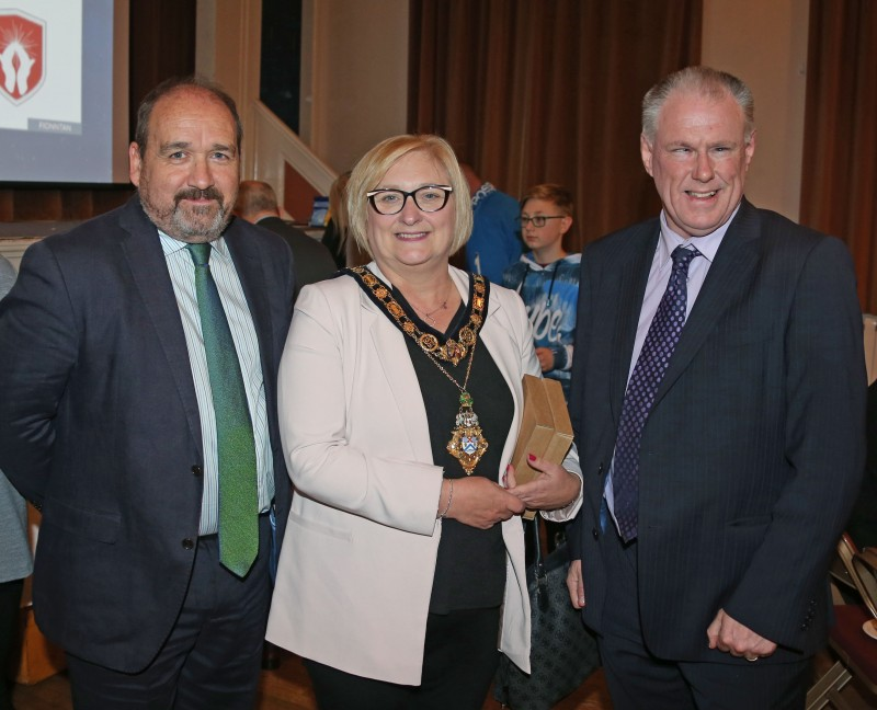 The Mayor of Causeway Coast and Glens Borough Council Councillor Brenda Chivers pictured with John Devlin from Dalriada School and Brian McAvoy from Ulster GAA at a reception in Ballymoney Town Hall for those who took part in the Cúchulainns cross community GAA initiative.