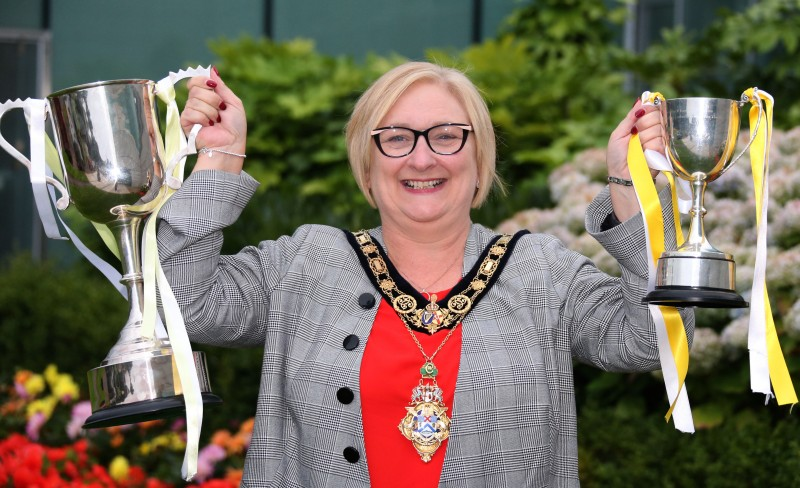 The Mayor of Causeway Coast and Glens Borough Council Councillor Brenda Chivers displays the All-Ireland trophies won by Antrim's Under 16 and Minor teams.