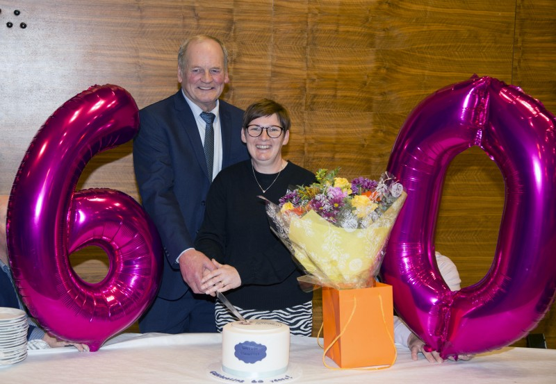 Liz McAfee and Robert Glass cut the special anniversary cake at the reception held in Cloonavin for Garvagh District Cancer Research Committee.