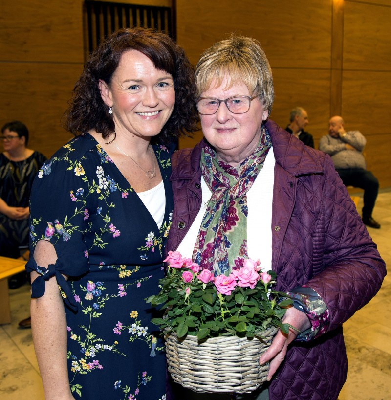 Lisa Bailey from Cancer research presents Maureen Black with flowers during the reception for Garvagh District Cancer Research Committee.