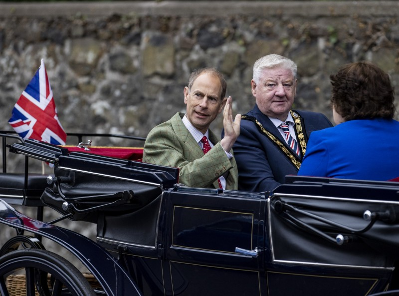 The Duke of Edinburgh rides in a Victorian carriage through Garvagh village with Mayor of Causeway Coast and Glens, Councillor Steven Callaghan QPM and Deputy Lord-Lieutenant for Co Londonderry Paula McIntyre MBE