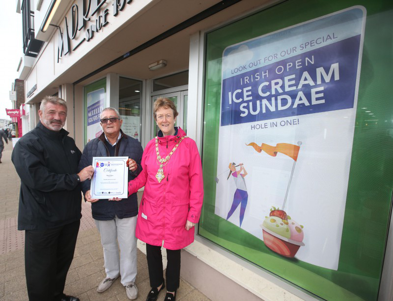 Nino Morelli pictured beside one of the themed windows at Morelli's on the Promenade in Portstewart receives the third place certificate from Eddie Rowan, Tourism NI and the Mayor of Causeway Coast and Glens Borough Council Councillor Joan Baird.