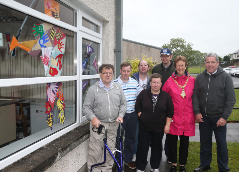 The Mayor of Causeway Coast and Glens Borough Council, Councillor Joan Baird OBE, pictured with members of Glenshane Care Association and their unique golf 'Titan' made using hand prints.