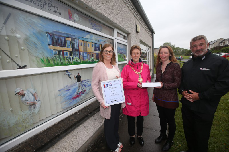 The Mayor of Causeway Coast and Glens Borough Council Councillor Joan Baird OBE presents an iPad to Stephanie Hilditch, manager of Glenshane Care Association in Dungiven, along with Annette Deighan from Causeway Chamber of Commerce and Eddie Rowan from Tourism NI