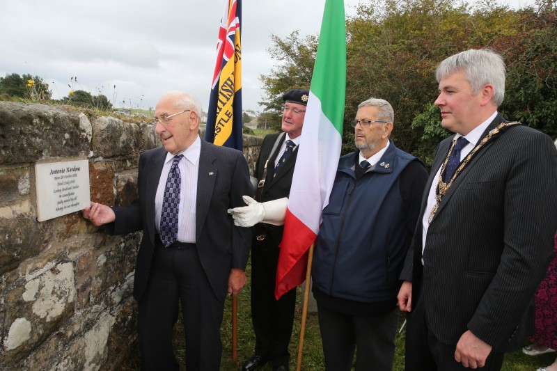 Ernest Nardone looks at the memorial plaque erected in his father’s memory at Bonamargy Friary along with Leonard Quigg and James McCurdy from Ballycastle Royal British Legion and the Mayor of Causeway Coast and Glens Borough Council Councillor Richard Holmes.