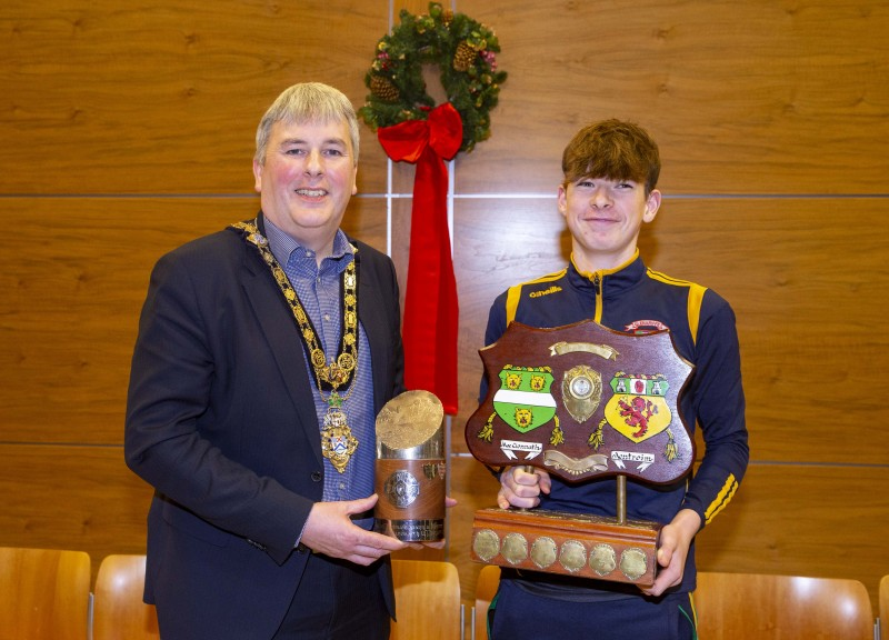 Captain of Glenariffe Oisins Under 15 team, Phelim Ward, pictured with the Mayor of Causeway Coast and Glens Borough Council Councillor Richard Holmes at the reception in Cloonavin.