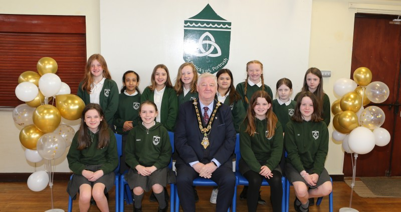 The Mayor, Councillor Steven Callaghan, joins the children of St. Patricks Primary School Portrush pictured with the girl’s Olympic handball team who played in the All-Ireland Olympic handball Finals last month.