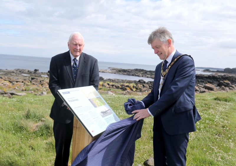 The Mayor of Causeway Coast and Glens Borough Council Alderman Mark Fielding unveils the new information panel at the site of the World War II arrow alongside Harry Cullen.