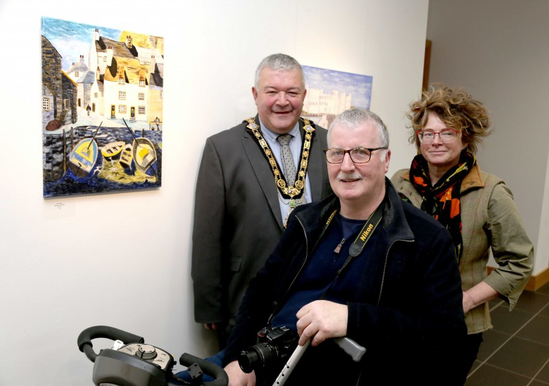 The Mayor of Causeway Coast and Glens Borough Council, Councillor Ivor Wallace, pictured at the opening of the Inside Out exhibition with the Pavestone Collective’s art tutor Louie Winward.