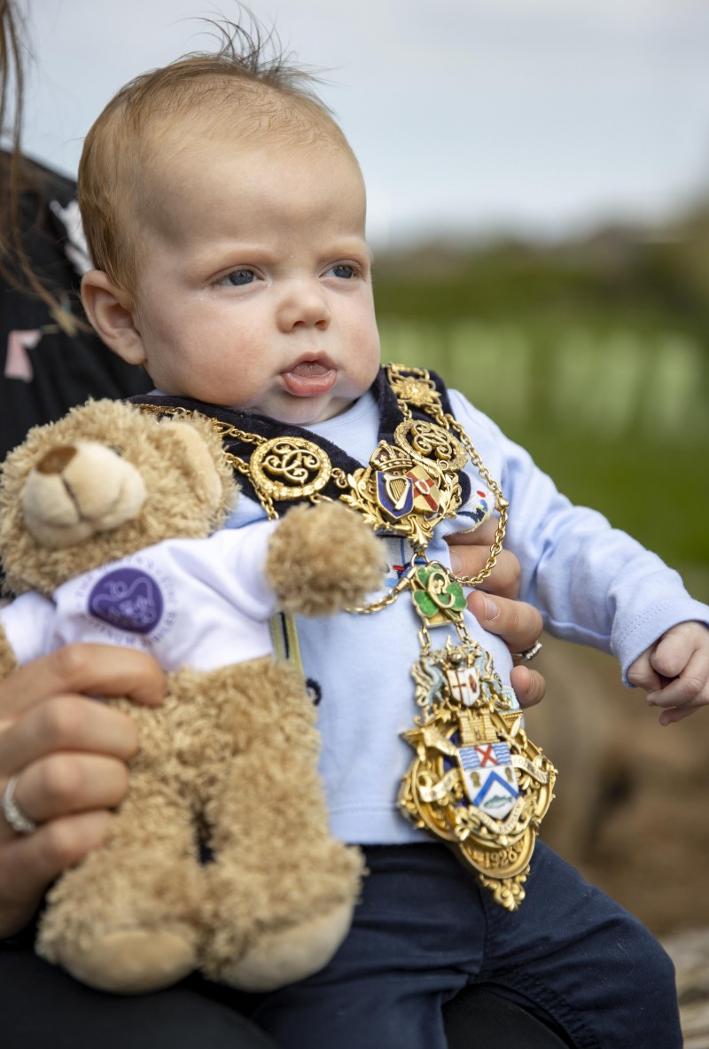 Albert McAuley, who was born on 6th February 2022, 70 years after HM The Queen’s accession, pictured with his Jubilee teddy bear while wearing the Mayor of Causeway Coast and Glens Borough Council’s chain of office.