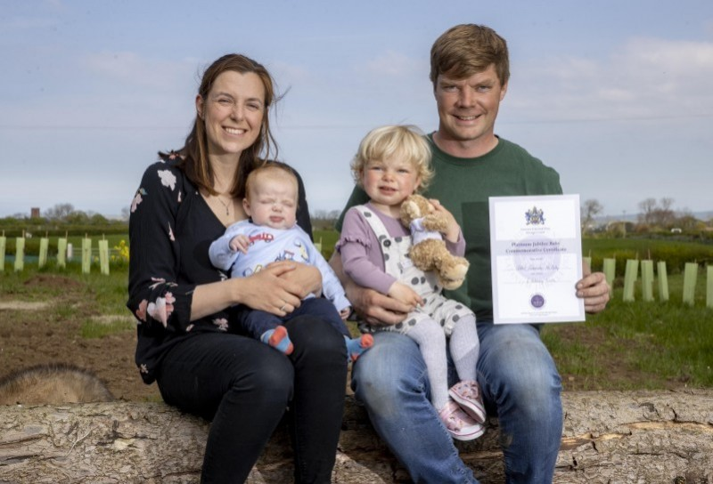 Hannah and Kyle McAuley pictured with their children Harper and Albert. Baby Albert was born on February 6th 2022, 70 years after HM The Queen’s accession, and to mark this special date he was recently presented with a teddy bear and certificate from Causeway Coast and Glens Borough Council.