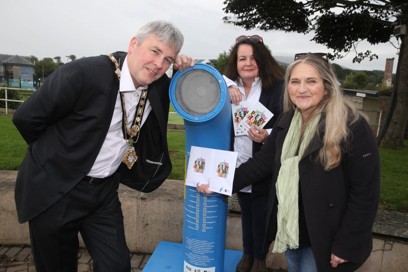 The Mayor of Causeway Coast and Glens Borough Council Councillor Richard Holmes listens to the Poetry Jukebox at Ballycastle seafront with the Desima Connolly from Causeway Coast and Glens Borough Council’s Arts team and Maria McManus from Poetry Ireland.