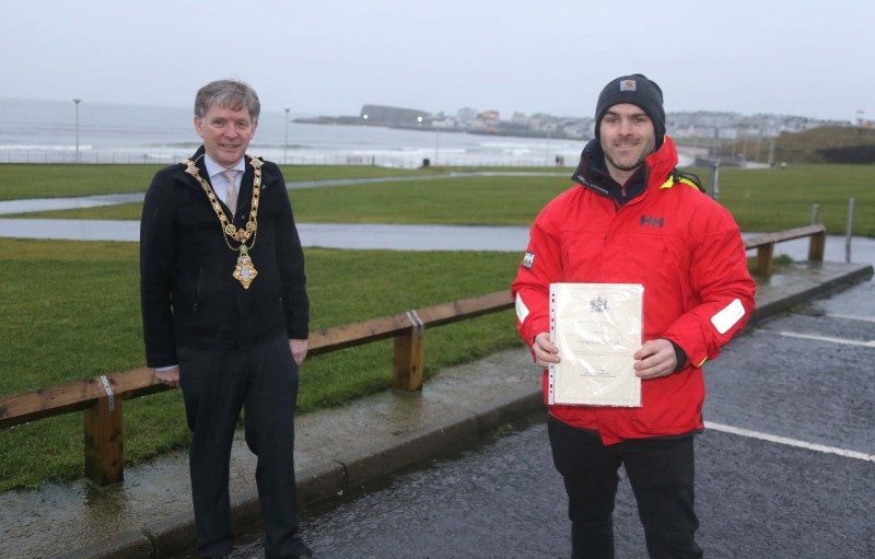 The Mayor of Causeway Coast and Glens Borough Council Alderman Mark Fielding pictured at West Strand in Portrush with Conard McCullough. The Mayor presented Conard with a certificate and a token of appreciation after he rescued his neighbour from a house fire earlier this month.