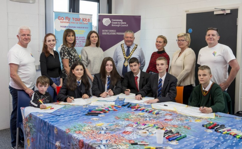 The Mayor of Causeway Coast and Glens Borough Council, Councillor Ivor Wallace, pictured with participants at the kite-making workshop. Also included are Go Fly Your Kite facilitators Glenn and George, Intermediate Labour Market Officer, Dearbhaile Hutchinson, Good Relations Manager, Patricia Harkin and ESOL class tutor, Dianne Buchannan.