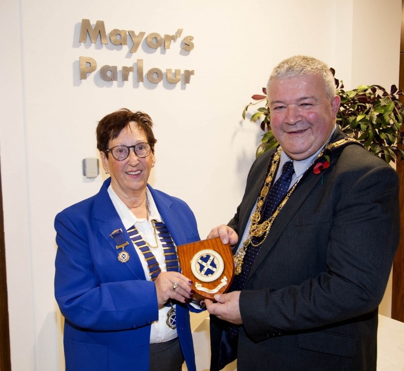 Liz Dallas, President of Limavady Recreation Club, presents the Mayor of Causeway Coast and Glens Borough Council, Councillor Ivor Wallace, with the club plaque during the reception in Cloonavin.