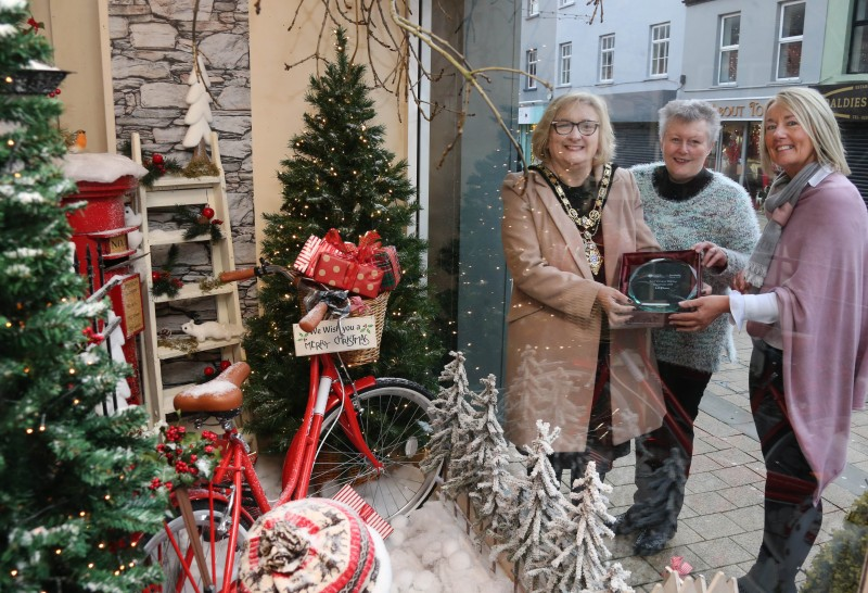 Patricia Kirkpatrick and Louise Moore from Lucy Goose, winner of the Christmas window competition in Limavady receive their award from the Mayor of Causeway Coast and Glens Borough Council Councillor Brenda Chivers.