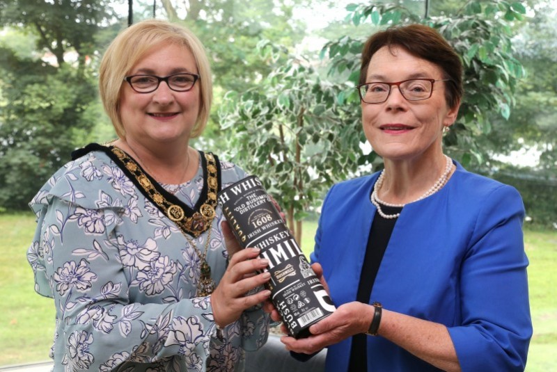 The Mayor of Causeway Coast and Glens Borough Council, Councillor Brenda Chivers presenting Catherine Mc Guinness, City of London Corporation Policy Chairperson with a bottle of Bushmills Irish Whiskey following a civic reception in Council Offices, Cloonavin.