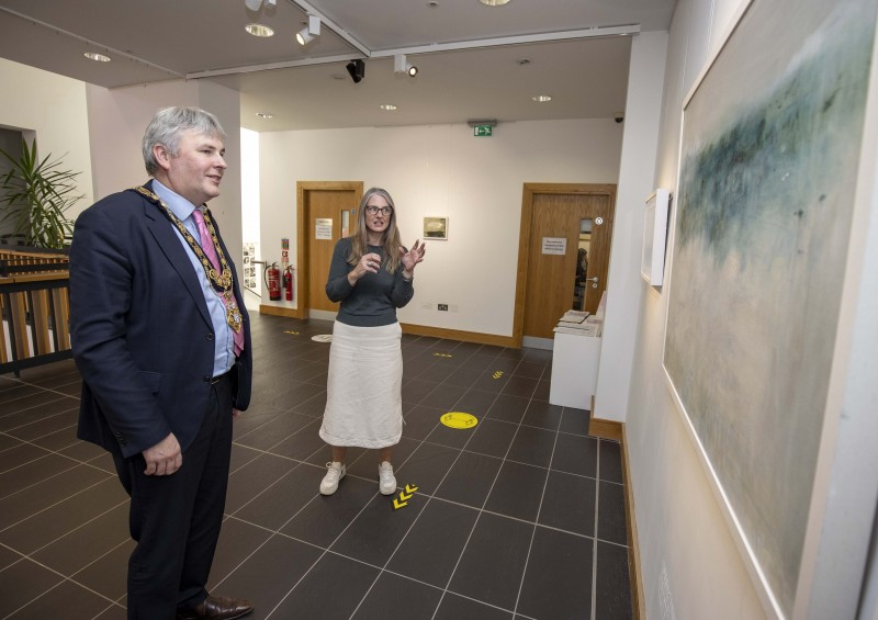 Artist Nicola Nemec shows the Mayor of Causeway Coast and Glens Borough Council Councillor Richard Holmes some of her work on display in the Beyond Edges exhibition at Roe Valley Arts and Cultural Centre.