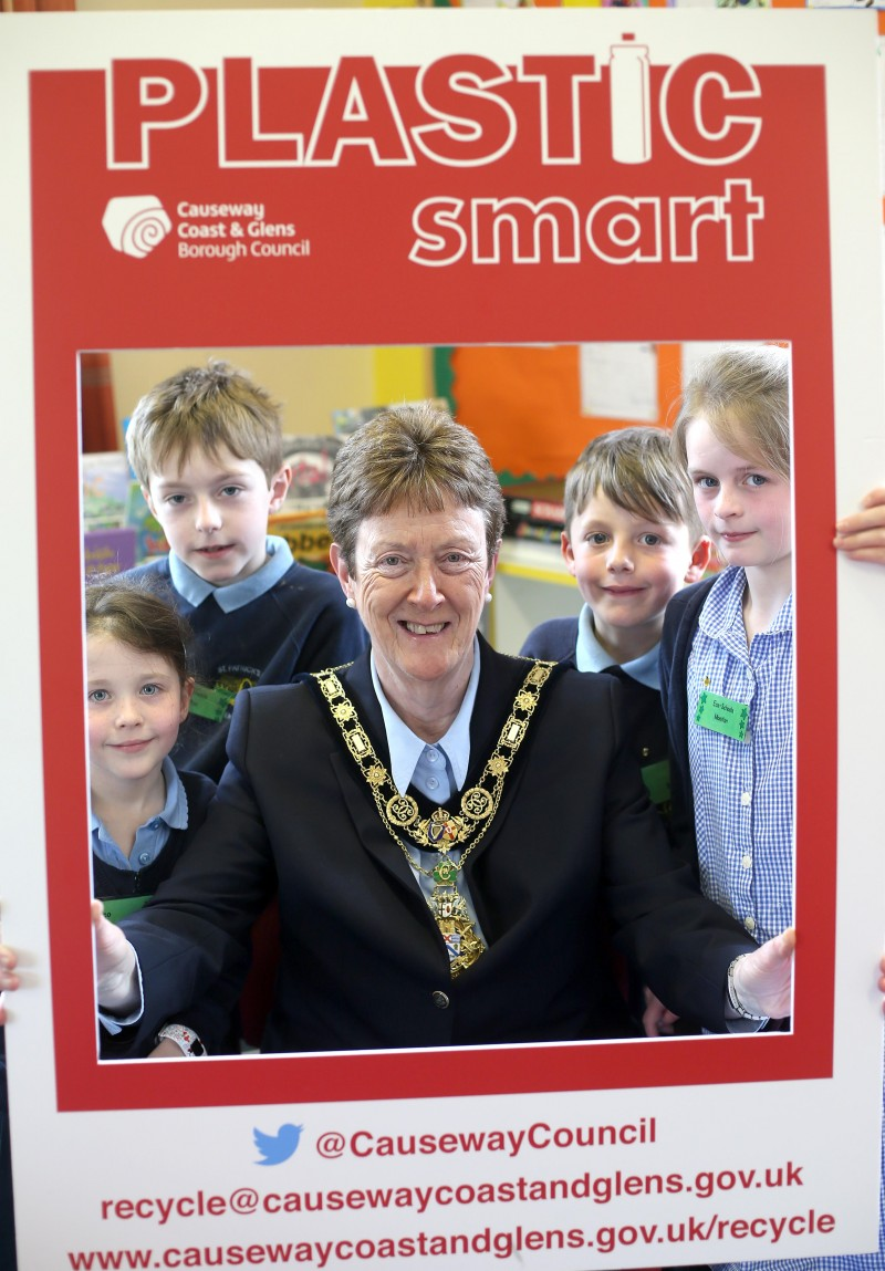 The Mayor of Causeway Coast and Glens Borough Council Councillor Joan Baird OBE helps pupils from St Patrick's Primary School in Glenariff celebrate their PlasticSmart award.
