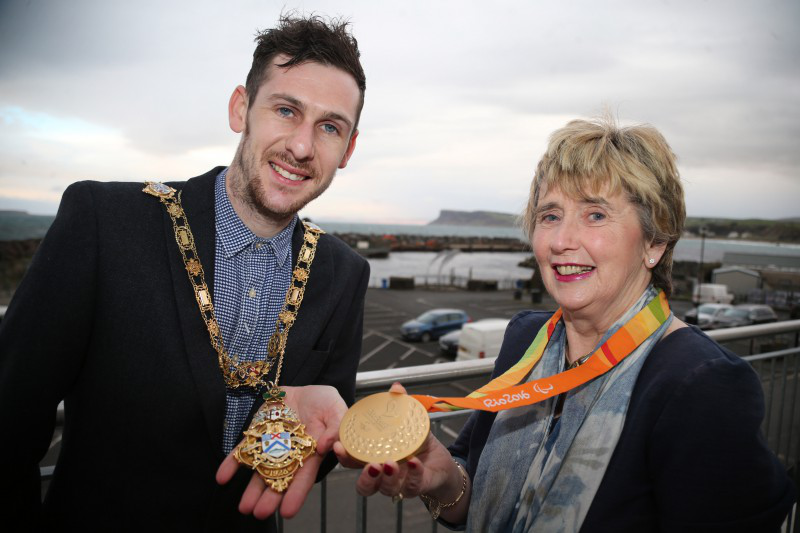 A golden moment for the Mayor of Causeway Coast and Glens Borough Council, Alderman Maura Hickey as she swaps her gold chain for one of Michael McKillop’s Paralympic gold medals during the reception held in his honour in Portnagree House, Ballycastle.