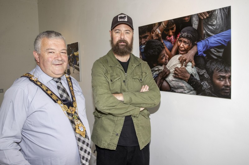 The Mayor of Causeway Coast and Glens Borough Council, Councillor Ivor Wallace, pictured with photojournalist Cathal McNaughton at the opening of his new exhibition, Reflection, at Flowerfield Arts Centre.