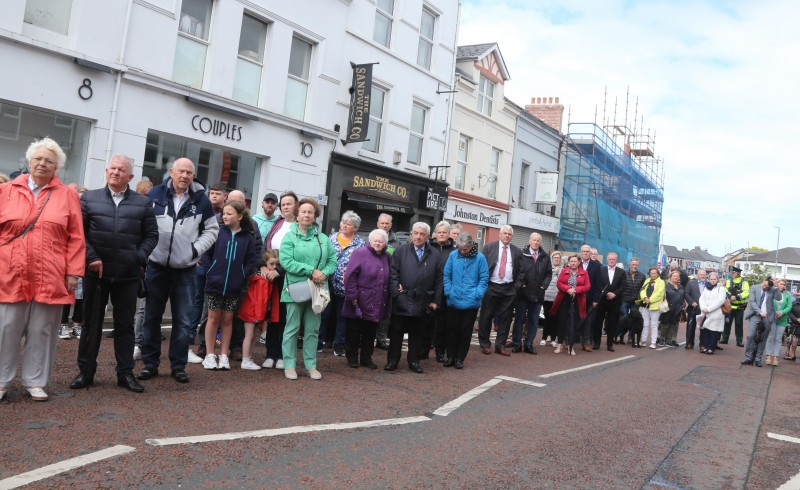 People gather on Railway Road in Coleraine to watch the dedication of the new memorial stone.
