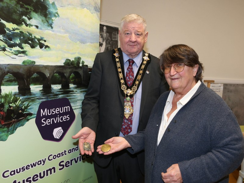 Mayor of Causeway Coast and Glens, Councillor Stephen Callaghan alongside Sally Forwood holding the fascinating artefacts that were donated.