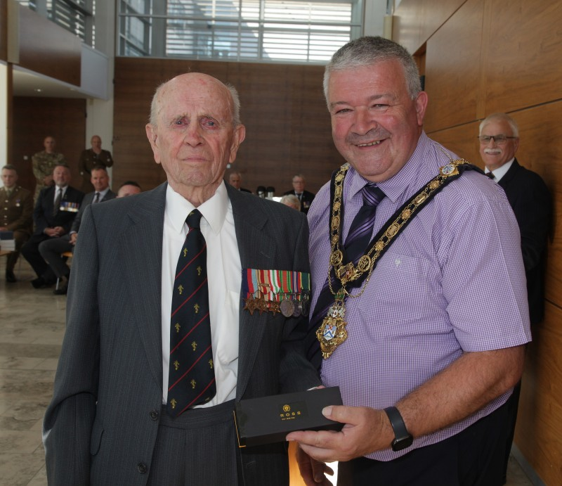 The Mayor of Causeway Coast and Glens Borough Council Councillor Ivor Wallace makes a presentation to Norman Irwin during the event in Cloonavin.
