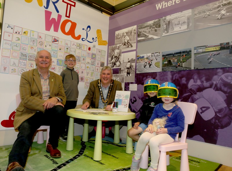 As well as featuring a selection of bikes, photographs, and memorabilia from the past 90 years of racing, ‘The Race and the Places’ NW200 exhibition at Ballymoney Museum includes a kid’s area and art wall. Creating their road racing tile designs are Joshua and Evelyn Austin (far right) and Bobby Acheson (left). Accompanying them are Robert Dixon (far left) and the Mayor of Causeway Coast and Glens Borough Council, Councillor Richard Holmes (centre).