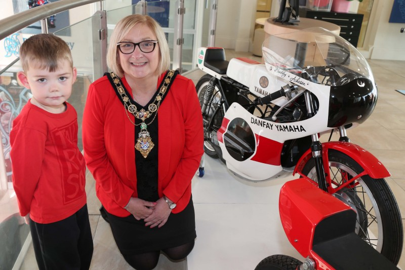 The Mayor of Causeway Coast and Glens Borough Council Councillor Brenda Chivers pictured with Bobby Acheson and his motorbike which is on loan to Ballymoney Museum as part of the ‘90 Years of NW 200’ exhibition.