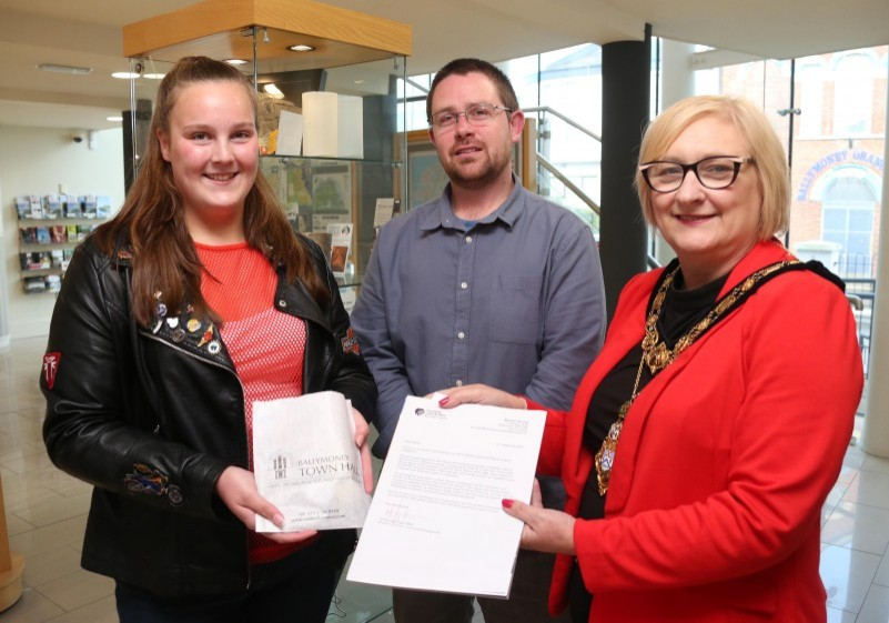 Rachel Barlow is pictured receiving her winning prize in this year’s ‘Capture the Moment’ Vauxhall International NW 200 photography competition from the Mayor of Causeway Coast and Glens Borough Council, Councillor Brenda Chivers and Nic Wright, Museum Services.