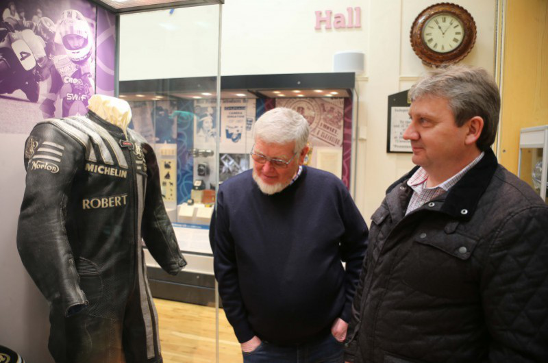 Stanley Murray and Kevin Hegarty look at one of the leather jackets on display at the exhibition in Ballymoney Museum.