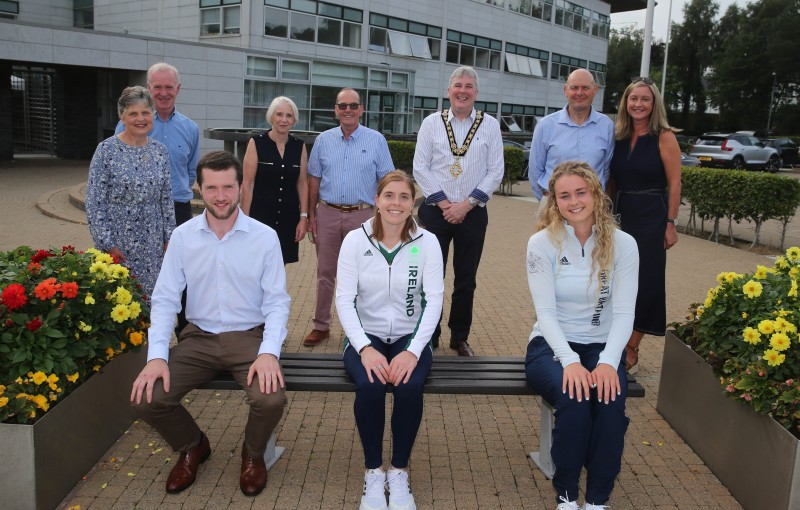 Pictured at Cloonavin are (seated) rower Hannah Scott, who represented Great Britain in the women's quadruple sculls and hockey player Katie Mullan who captained Ireland’s hockey tea at the Tokyo Olympics, alongside Neil Johnston who won the 5000m at the Manchester International athletics event, with (standing) family members and the Mayor of Causeway Coast and Glens Borough Council Richard Holmes